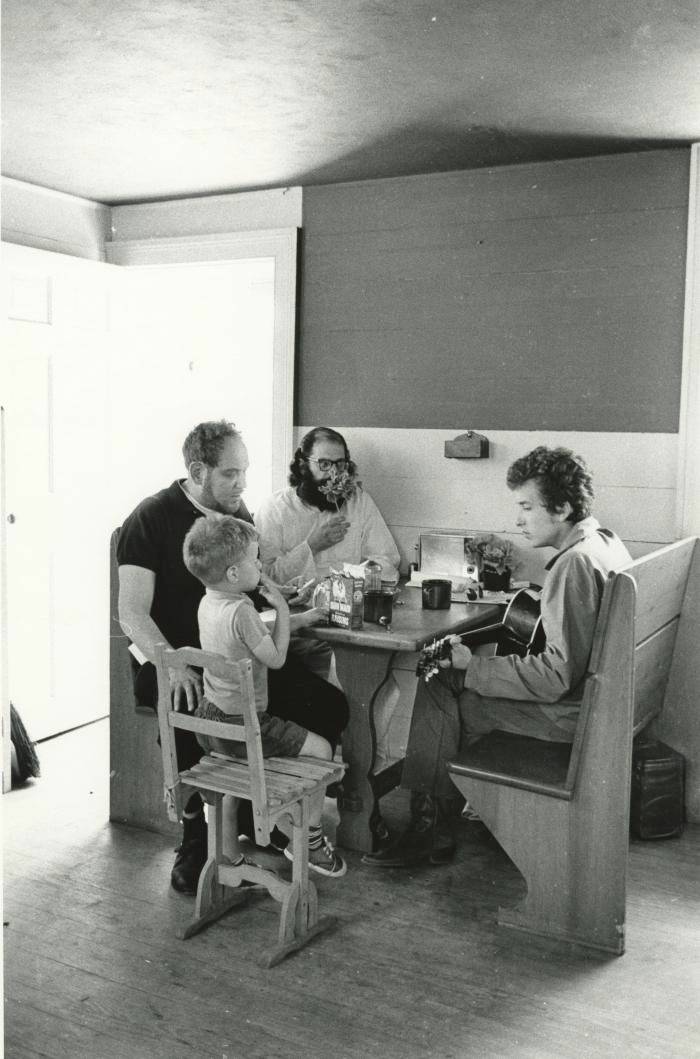 photograph of Bob Dylan and friends sitting in a kitchen